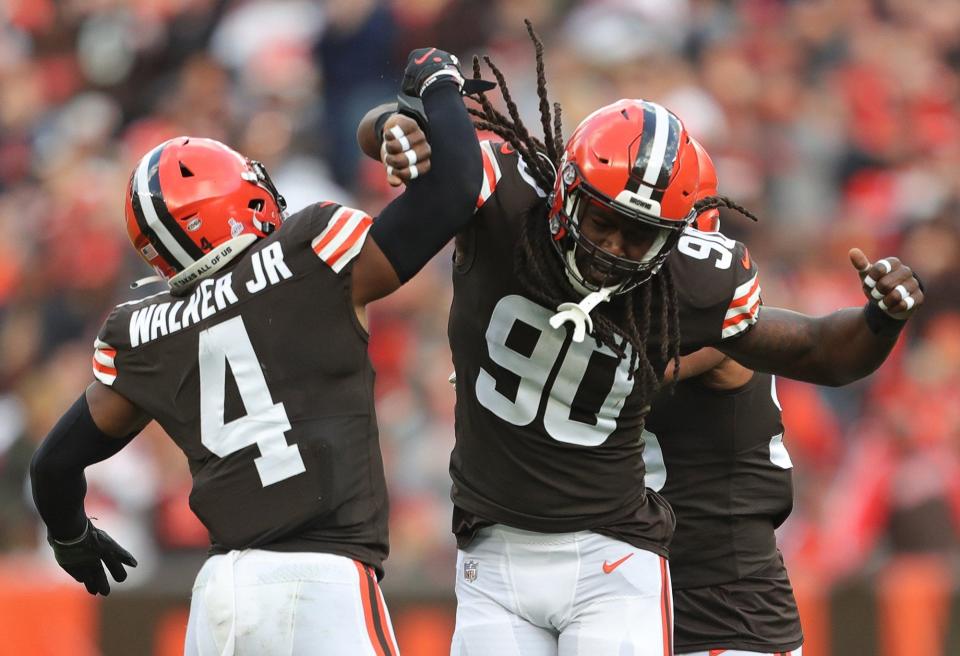 Cleveland Browns defensive end Jadeveon Clowney (90) celebrates with Cleveland Browns middle linebacker Anthony Walker (4) after sacking Arizona Cardinals quarterback Kyler Murray (1) during the first half of an NFL football game at FirstEnergy Stadium, Sunday, Oct. 17, 2021, in Cleveland, Ohio. [Jeff Lange/Beacon Journal]