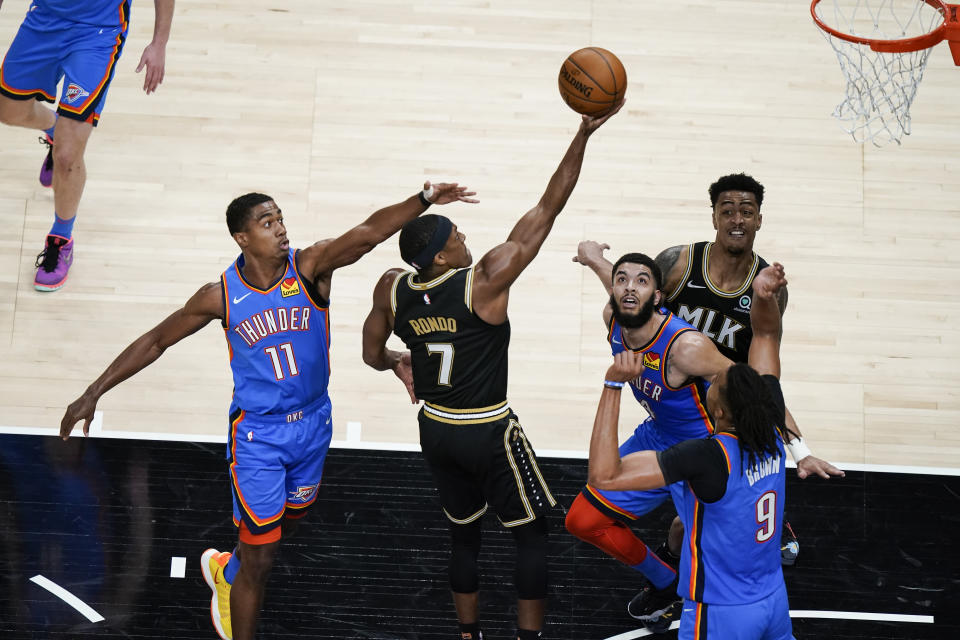 Atlanta Hawks' Rajon Rondo (7) shoots and scores against Oklahoma City Thunder guard Theo Maledon (11) during the second half of an NBA basketball game on Thursday, March 18, 2021, in Atlanta. (AP Photo/Brynn Anderson)