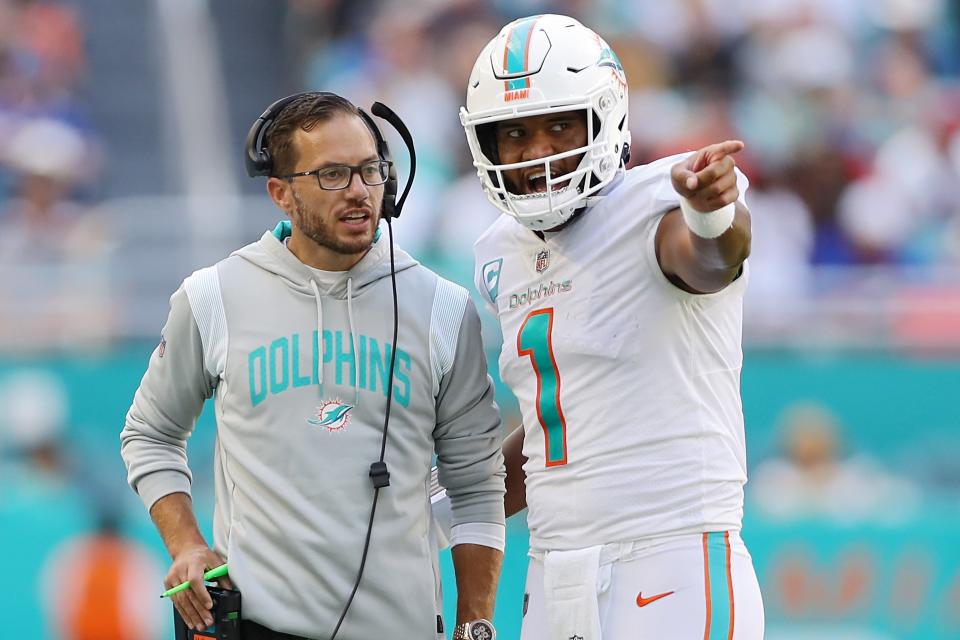 Dolphins coach Mike McDaniel speaks with quarterback Tua Tagovailoa in the fourth quarter against the Buffalo Bills, Sept. 25, 2022.