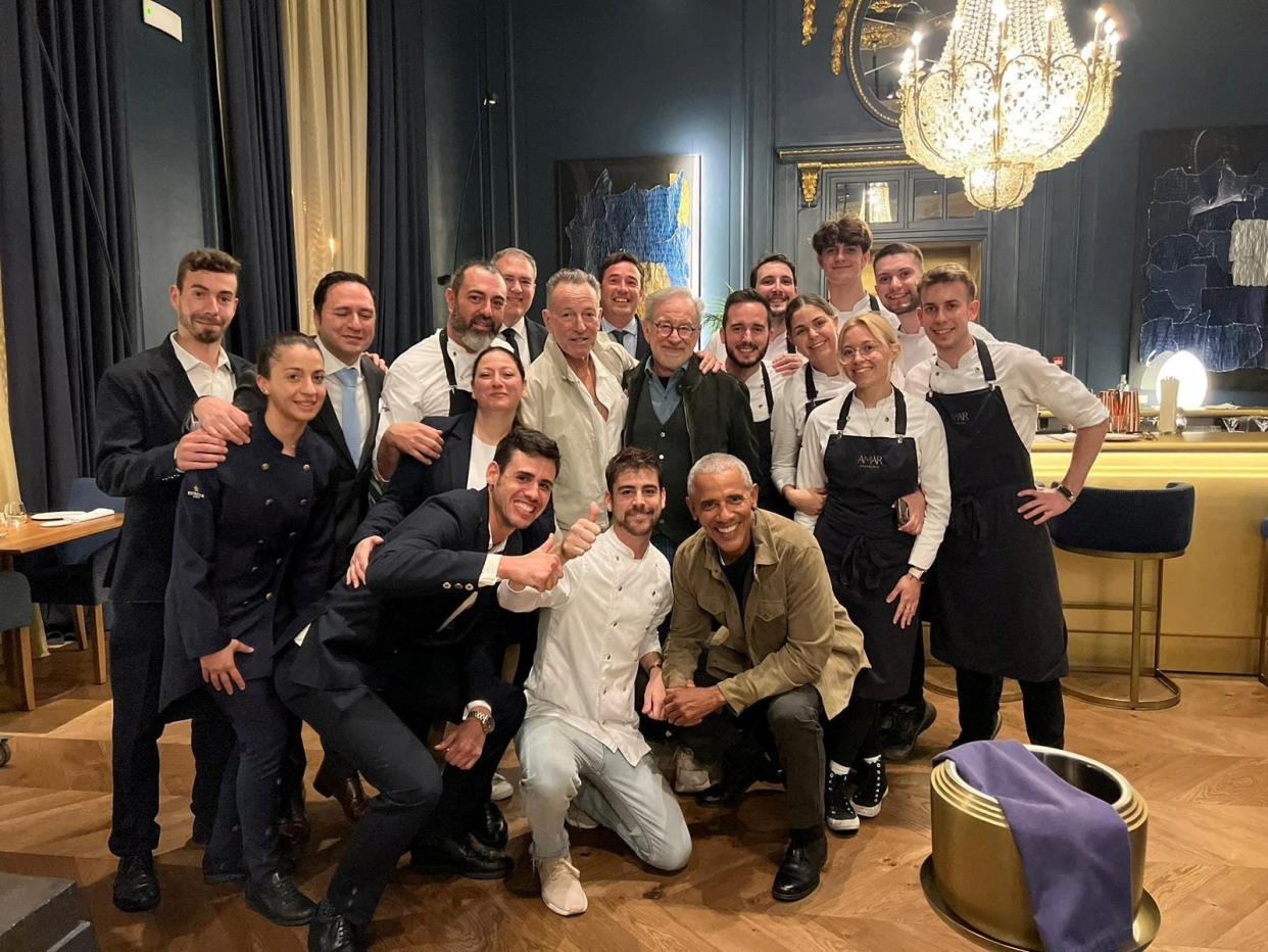 Former US President Barack Obama, film director Steven Spielberg and singer Bruce Springsteen pose for a picture with Amar restaurant staff in Barcelona, Spain April 27, 2023.