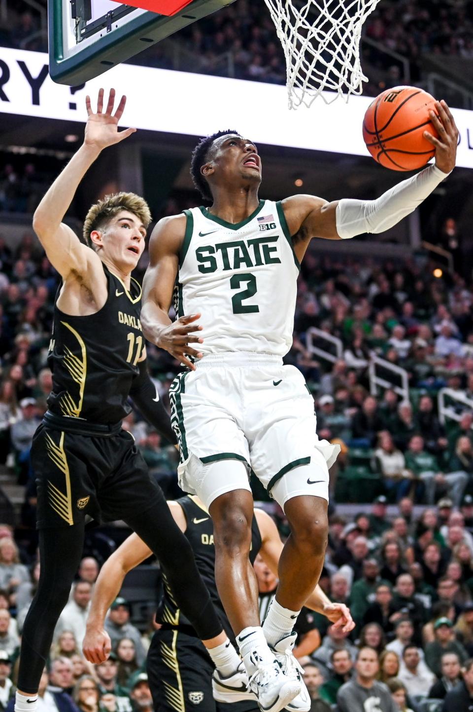 Michigan State's Tyson Walker, right, scores as Oakland's Blake Lampman defends during the first half on Monday, Dec. 18, 2023, at the Breslin Center in East Lansing.