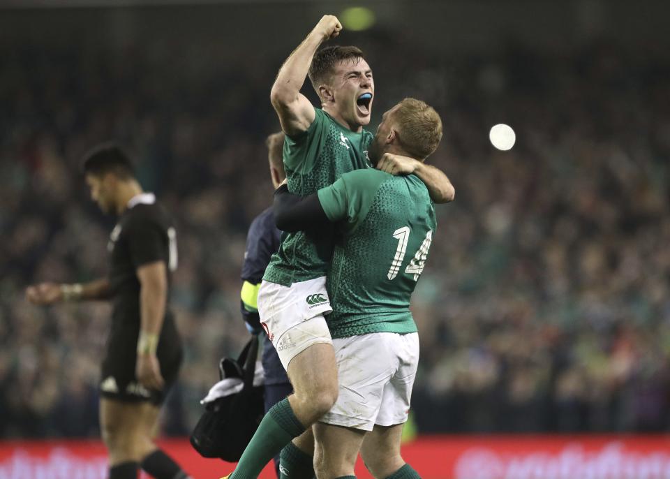 Ireland's Luke McGrath, left, celebrates with Ireland's Keith Earls after the rugby union international between Ireland and the New Zealand All Blacks in Dublin, Ireland, Saturday, Nov. 17, 2018. Ireland won the match 16-9. (AP Photo/Peter Morrison)