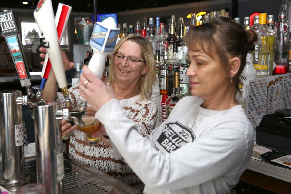 Shellukes bartenders Chrissy Dodson, left, who has worked eight years at the bar and grill, and Tracy Proffitt, for 20 years, will help celebrate Shellukes' 20th anniversary Tuesday.