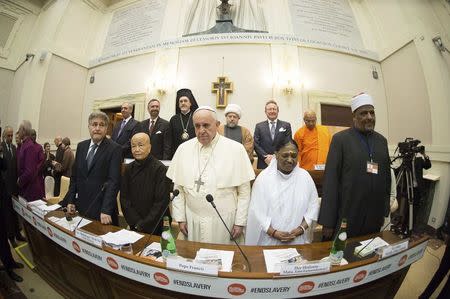 Pope Francis (front C) poses with religious leaders during a meeting at the Pontifical Academy of Sciences at the Vatican December 2, 2014. REUTERS/Osservatore Romano