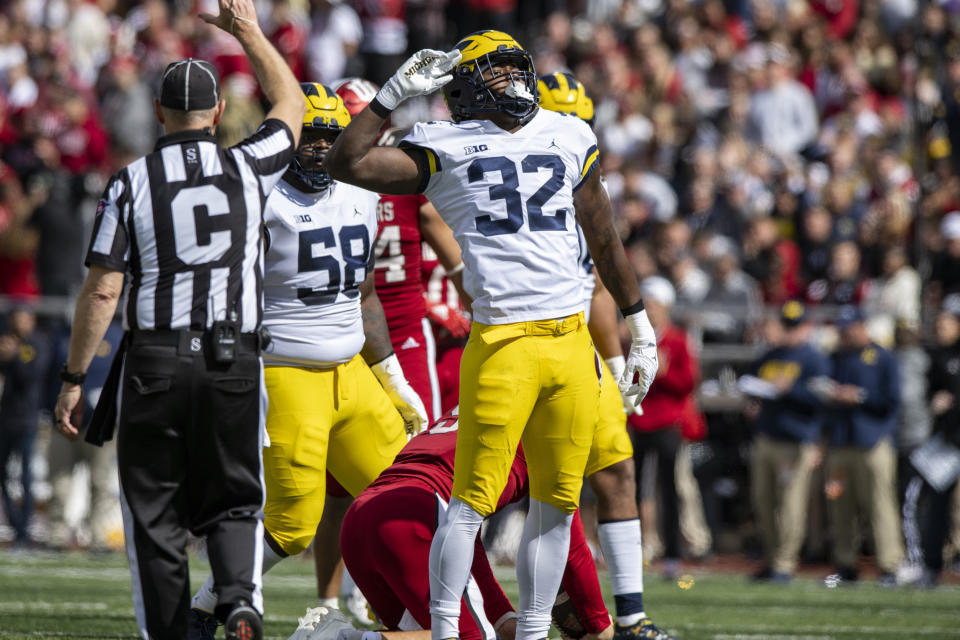 Michigan linebacker Jaylen Harrell (32) reacts after sacking Indiana quarterback Connor Bazelak (9) during the first half of an NCAA college football game, Saturday, Oct. 8, 2022, in Bloomington, Ind. (AP Photo/Doug McSchooler)