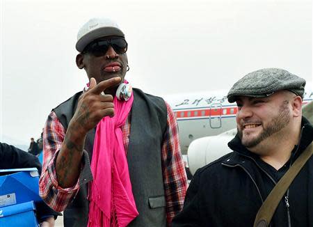 Former NBA basketball star Dennis Rodman (L) arrives at Pyongyang airport in Pyongyang, in this photo released by Kyodo January 6, 2014. REUTERS/Kyodo