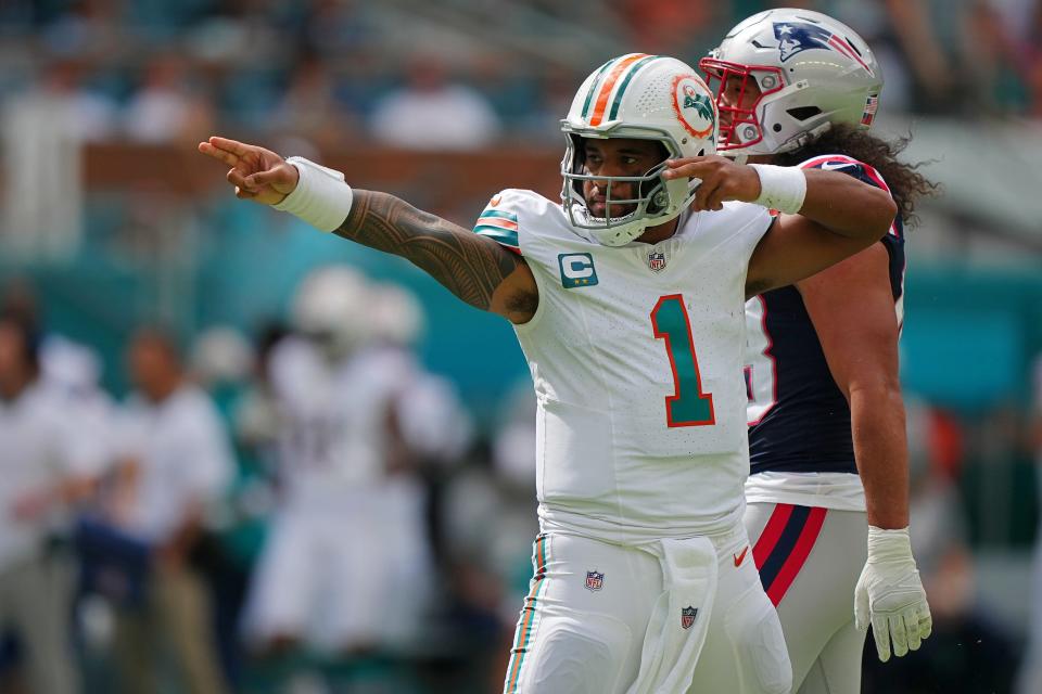 Oct 29, 2023; Miami Gardens, Florida, USA; Miami Dolphins quarterback Tua Tagovailoa (1) celebrates after running the ball for a first down against the New England Patriots during the first half at Hard Rock Stadium. Mandatory Credit: Jasen Vinlove-USA TODAY Sports