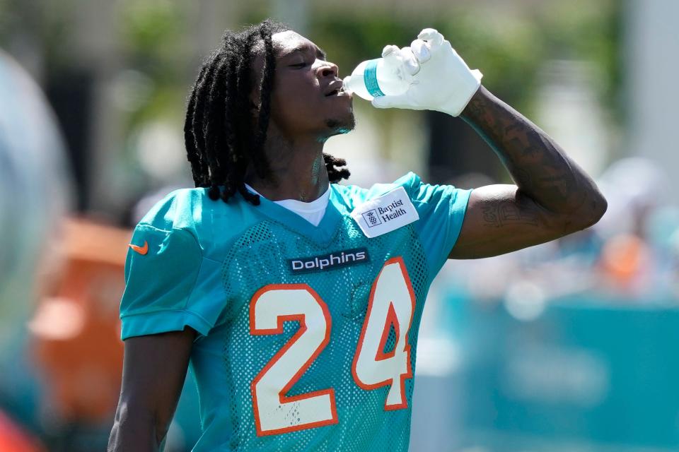 Miami Dolphins cornerback Cam Smith (24) drinks during practice at the NFL football team's training facility, Sunday, July 30, 2023, in Miami Gardens, Fla. (AP Photo/Lynne Sladky)