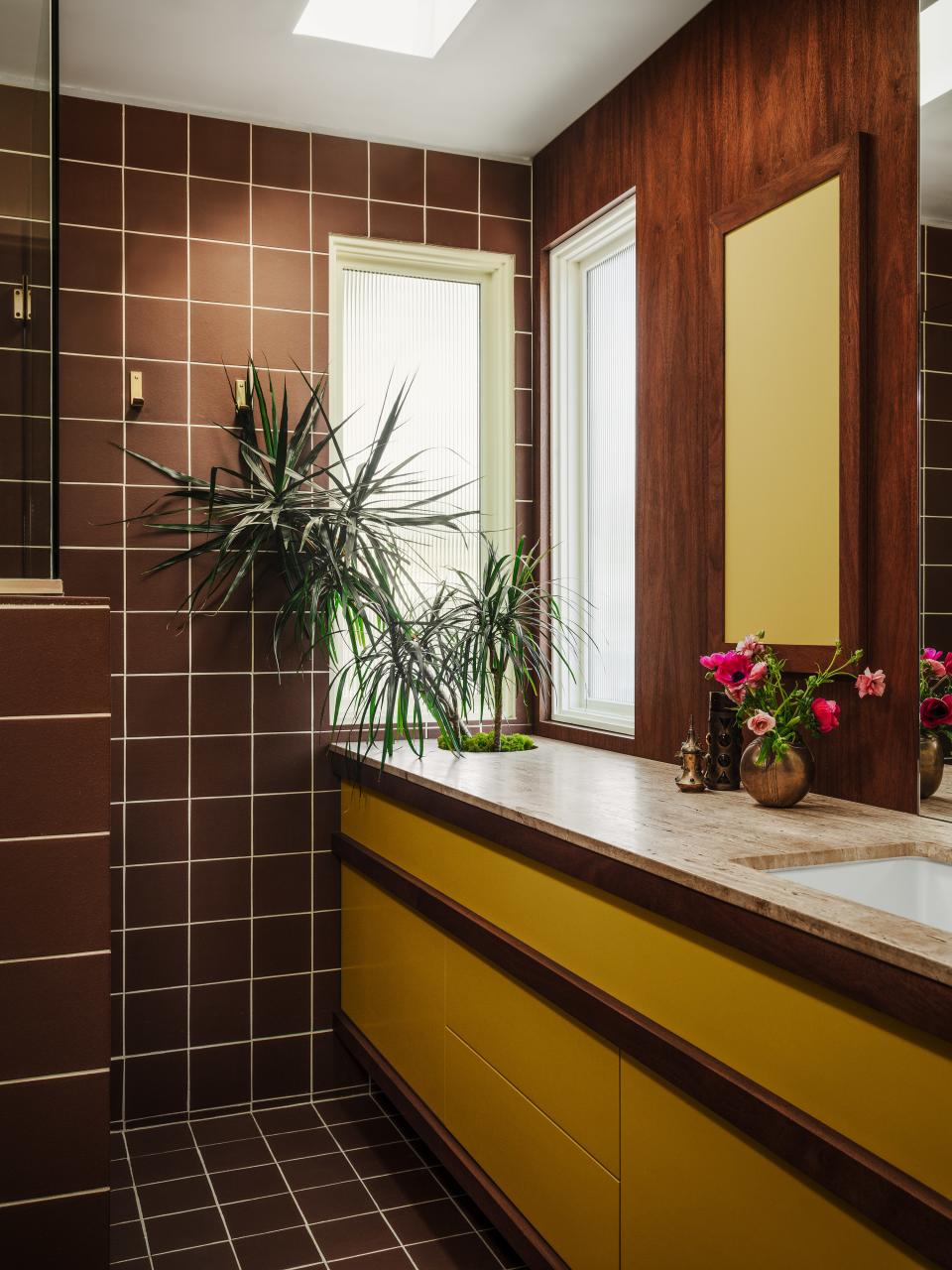 The primary bathroom features a plant space built right into the vanity, the perfect way to bring the outdoors in.