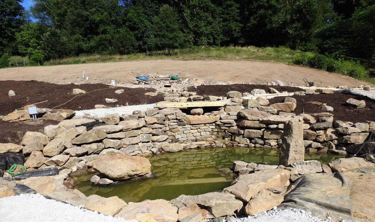 A new pond with a waterfall at Clary Gardens is nearing completion. It exists behind an events pavilion and will be an added attraction for wedding receptions and special occasions.