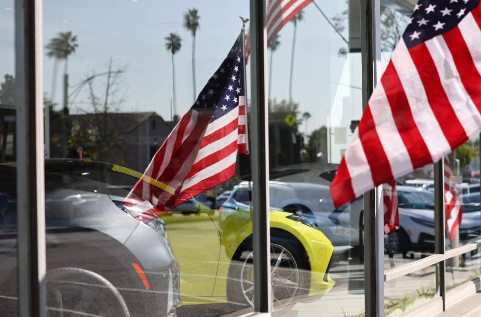 GLENDALE, CALIFORNIA - FEBRUARY 15: American flags fly near new Chevrolets displayed for sale in a Chevrolet dealership on February 15, 2023 in Glendale, California. The Commerce Department released data today showing that retail sales saw a three percent jump in January, the biggest gain in almost two years. Sales increased 6.4 percent at automobile and other vehicle dealers. (Photo by Mario Tama/Getty Images)