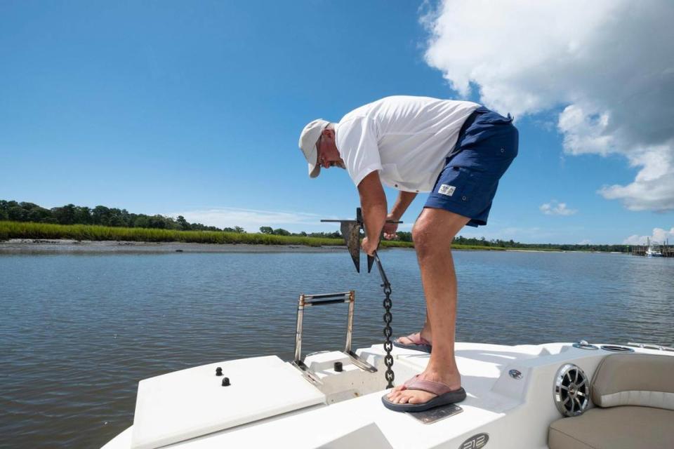 Captain Doug Allen sets anchor near the Calabash, N.C. waterfront just off the Intracoastal Waterway. Retired from the ‘corporate grind’, the captain uses the GetMyBoat.com booking service to generate customers for his service. Aug. 8, 2022.