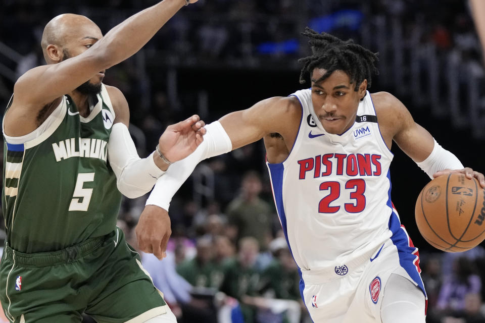 Detroit Pistons guard Jaden Ivey (23) drives as Milwaukee Bucks guard Jevon Carter (5) defends during the second half of an NBA basketball game, Monday, March 27, 2023, in Detroit. (AP Photo/Carlos Osorio)