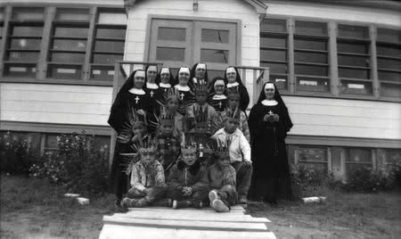 FILE PHOTO: Sisters from the Soeurs du Sacre-Coeur d'Ottawa pose with students at the Pukatawagan Residential School, in Pukatawagan, Manitoba in a 1960 archive photo. REUTERS/Sister Liliane/Library and Archives Canada/PA-195120/handout via Reuters