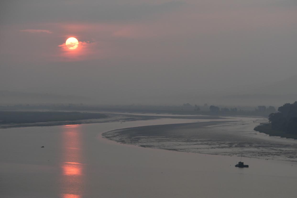 <span class="article-embeddable-caption">The sun rises over North Korea and the Yalu River which forms the border between China and North Korea, as seen from Dandong, China on Sept. 5, 2017. Thousands of North Koreans swam through the Yalu River over the years to escape their home country.</span><cite class="article-embeddable-attribution">Source: Greg Baker/Getty Images</cite>