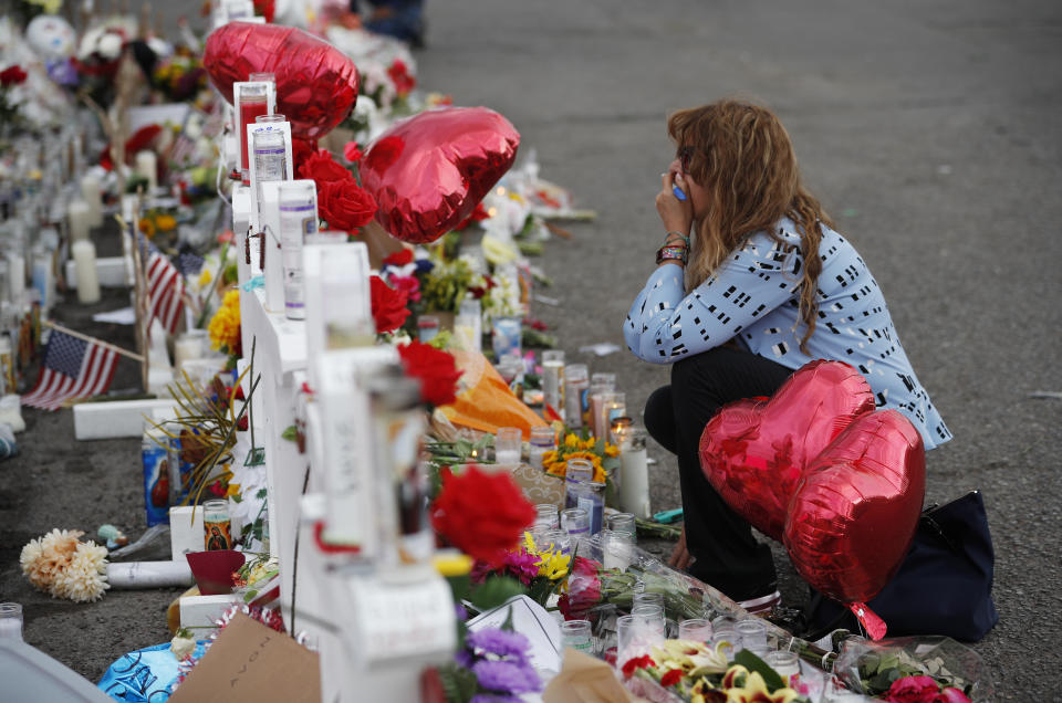 Gloria Garces kneels in front of crosses at a makeshift memorial near the scene of the mass shooting in El Paso, Texas. (Photo: ASSOCIATED PRESS)