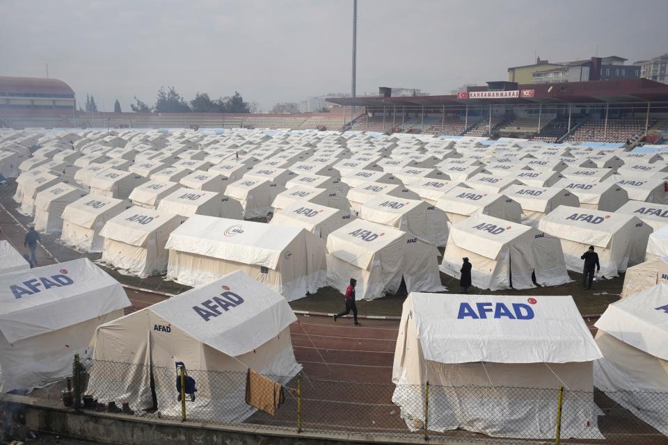 People arrive at the tents that were setup to accommodate earthquake survivors, in Kharamanmaras, southeastern Turkey, Friday, Feb. 10, 2023. Rescuers pulled several people alive from the shattered remnants of buildings on Friday, some who survived more than 100 hours trapped under crushed concrete in the bitter cold after a catastrophic earthquake slammed Turkey and Syria. (AP Photo/Kamran Jebreili)