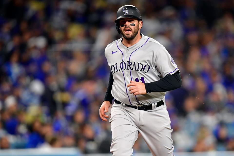 Apr 3, 2023; Los Angeles, California, USA; Colorado Rockies third baseman Mike Moustakas (11) scores a run against the Los Angeles Dodgers fifth inning at Dodger Stadium. Mandatory Credit: Gary A. Vasquez-USA TODAY Sports