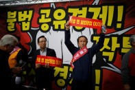 Taxi drivers take part in a protest against a carpool service application that will be launched by Kakao Corp later this year, in central Seoul, South Korea, October 18, 2018. The banners read, "Stop carpool service application, it is illegal business". REUTERS/Kim Hong-Ji