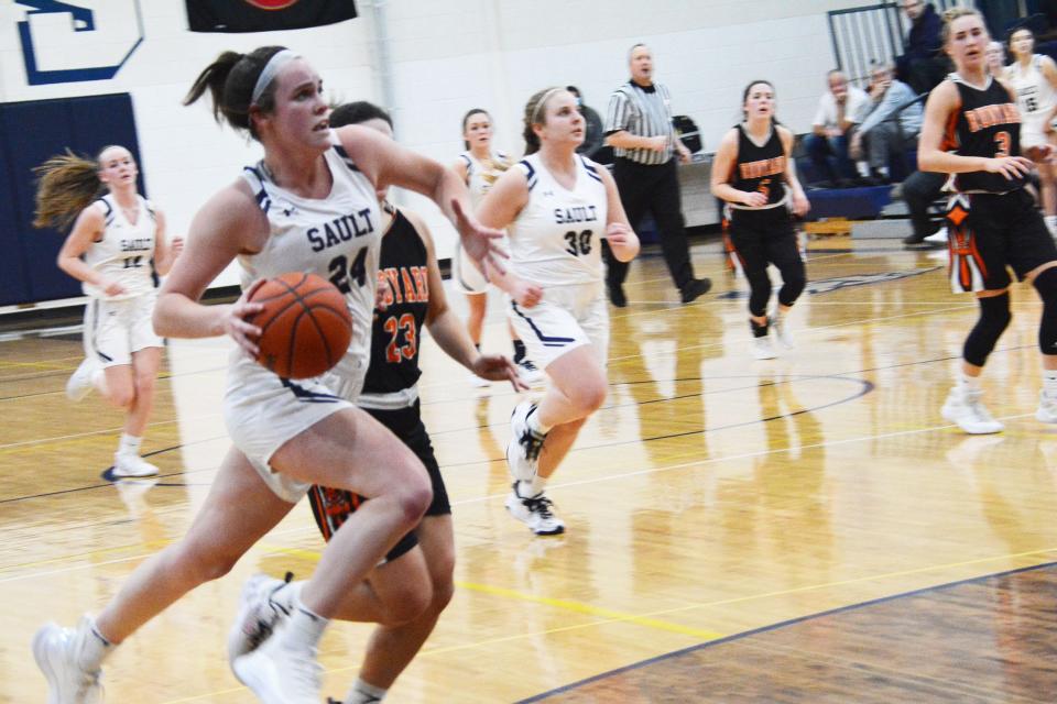 Sault High's Claire Erickson (24) leads a fast break against Rudyard Thursday night. The Blue Devils won 58-32.