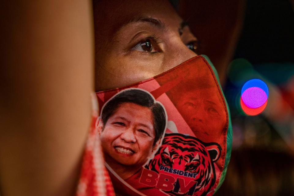 A supporter is seen wearing a facemask with a portrait of Ferdinand "Bongbong" Marcos Jr. during his last campaign rally before the election on May 07, 2022 in Paranaque, Metro Manila, Philippines. Candidates for the May 9 presidential elections held their final campaign rallies two days before millions of Filipinos head to the polls to elect the country's new set of leaders. The son and namesake of ousted dictator Ferdinand Marcos Sr., who was accused and charged of amassing billions of dollars of ill-gotten wealth as well as committing tens of thousands of human rights abuses during his autocratic rule, has mounted a hugely popular campaign to return his family name to power. Ferdinand "Bongbong" Marcos Jr. enjoys a wide lead in opinion polls against his main rival, Vice President Leni Robredo, owing to a massive disinformation campaign that has effectively rebranded the Marcos dictatorship as a "golden age." Marcos is running alongside Davao city Mayor Sara Duterte, the daughter of outgoing President Rodrigo Duterte who is the subject of an international investigation for alleged human rights violations during his bloody war on drugs.