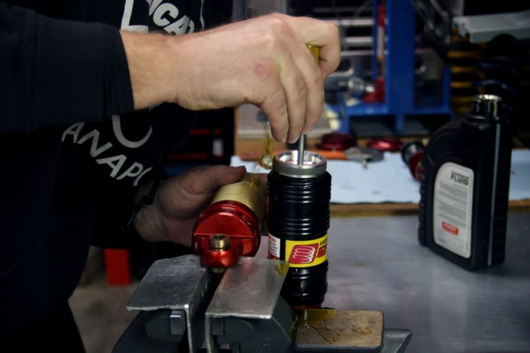 Matt intentionally overfills the reservoir before installing the piston, to help ensure as little air as possible will need to be purged. It's a messy step, but a necessary one.