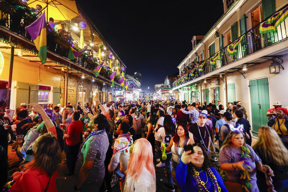 Revelers walk along Bourbon street on the Friday before Mardi Gras Day in New Orleans, Feb. 9, 2024. (Sophia Germer/The Times-Picayune/The New Orleans Advocate via AP)