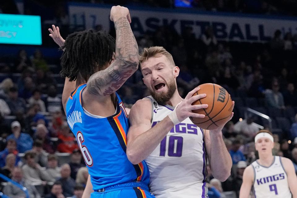 Sacramento Kings forward Domantas Sabonis (10) drives past Oklahoma City Thunder forward Jaylin Williams (6) in the first half of an NBA basketball game Sunday, Feb. 26, 2023, in Oklahoma City. (AP Photo/Sue Ogrocki)