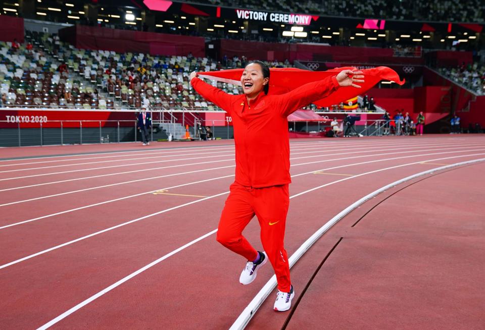 <p>Liu Shiying of Team China celebrates with the national flag after winning gold in the Women's Javelin Final. </p>