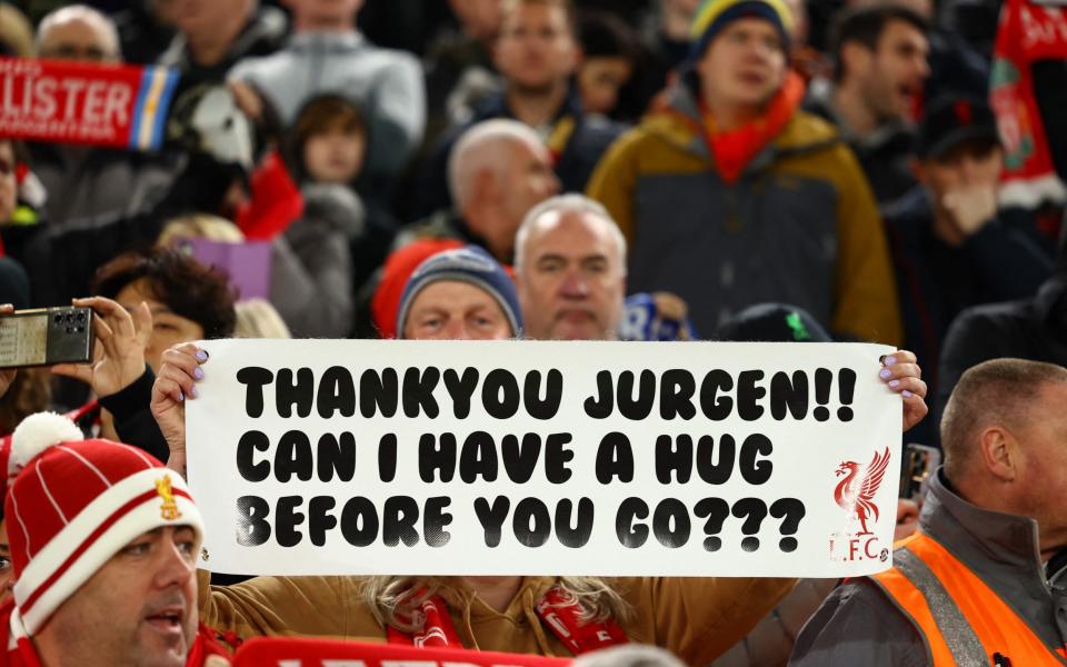 Liverpool fan with a sign in support of manager Juergen Klopp inside the stadium before the match