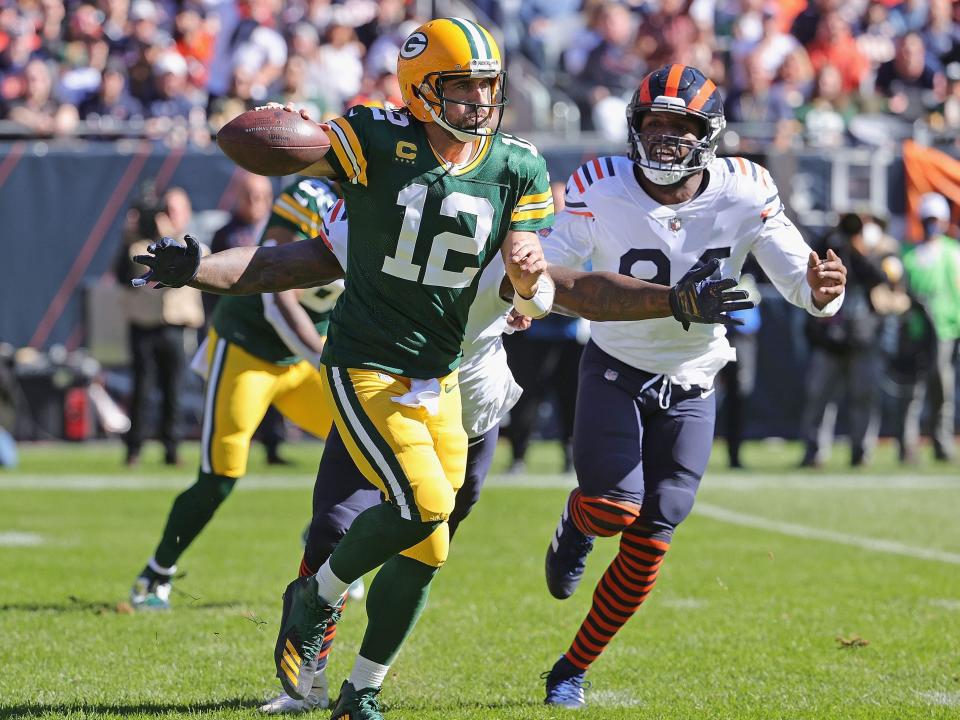 Aaron Rodgers escapes pressure from the Chicago Bears defense.