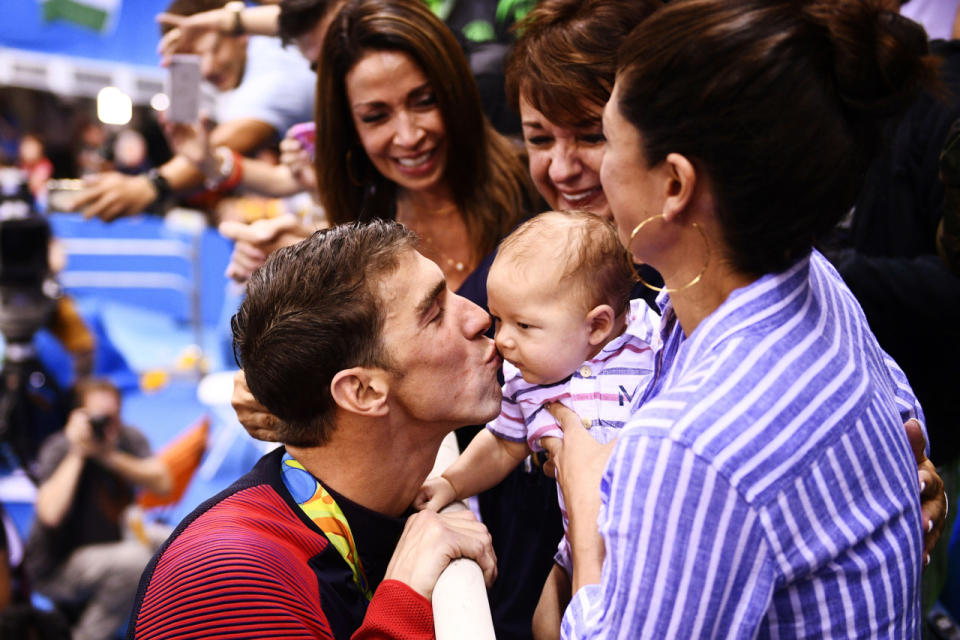 <p>Michael Phelps kisses his son, Boomer, after winning the men’s 200-meter butterfly final.</p>
