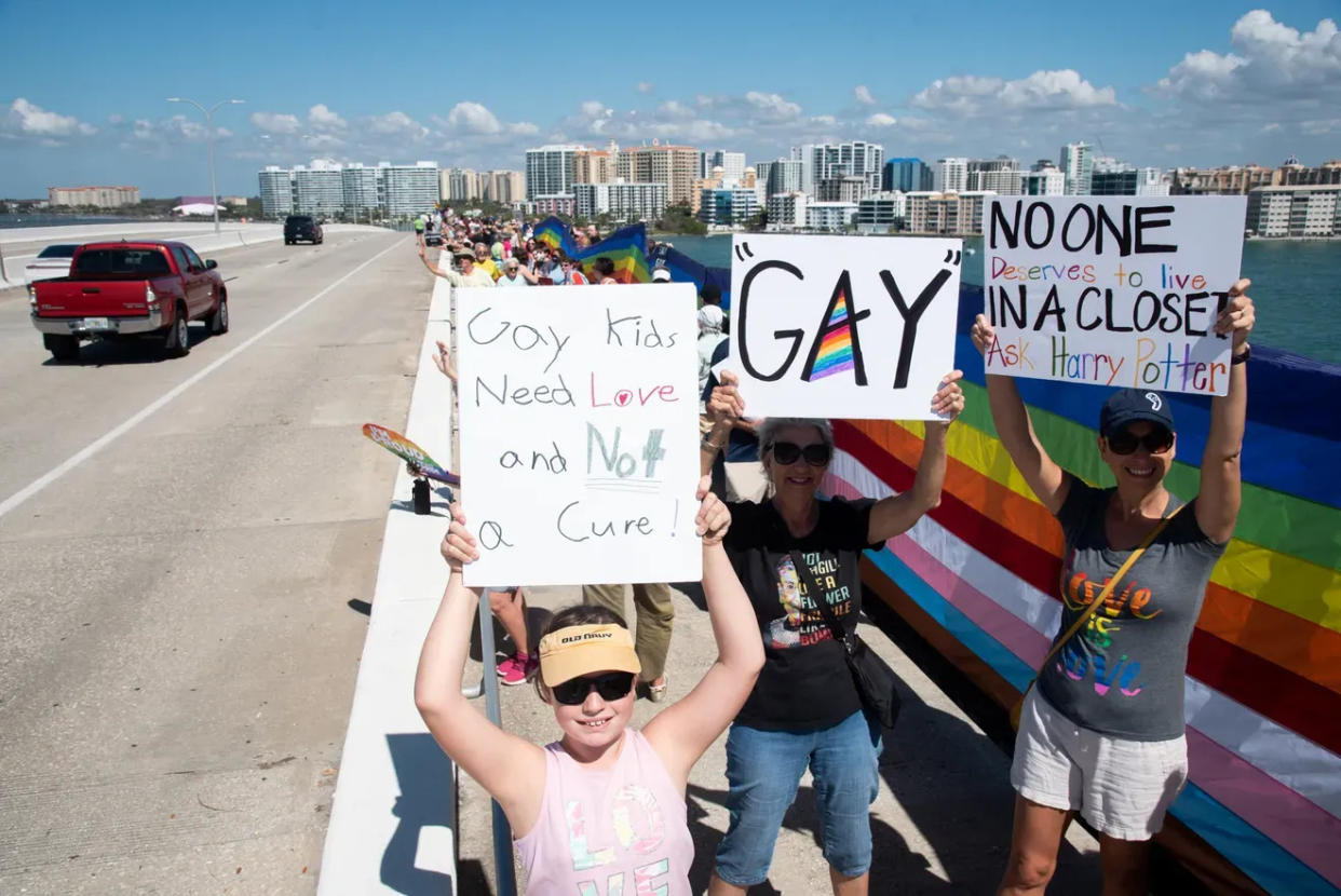 LGBTQ residents and supporters rally and wave a 700-foot pride flag on Ringling Bridge, in Sarasota, in 2022. They were  protesting the "Don't Say Gay" law.