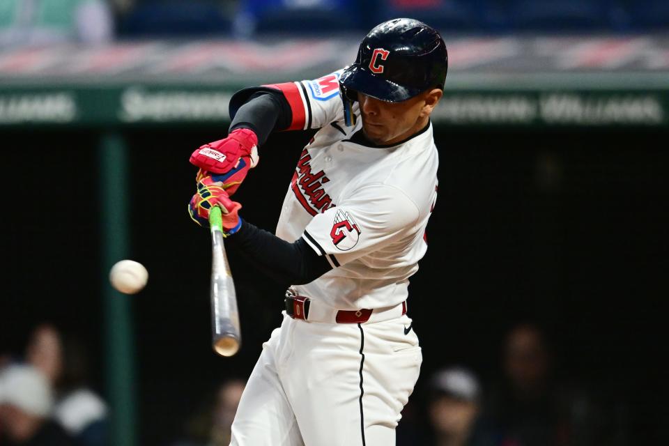 Apr 19, 2024; Cleveland, Ohio, USA; Cleveland Guardians second baseman Andres Gimenez (0) hits an RBI single during the fifth inning against the Oakland Athletics at Progressive Field. Mandatory Credit: Ken Blaze-USA TODAY Sports