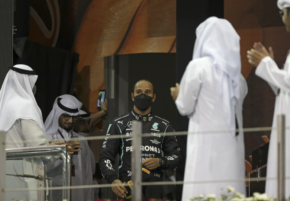 Mercedes driver Lewis Hamilton of Britain walks onto the podium after finishing second in the Formula One Abu Dhabi Grand Prix in Abu Dhabi, United Arab Emirates, Sunday, Dec. 12. 2021. Max Verstappen ripped a record eighth title away from Lewis Hamilton with a pass on the final lap of the Abu Dhabi GP to close one of the most thrilling Formula One seasons in years as the first Dutch world champion. (AP Photo/Kamran Jebreili, Pool)