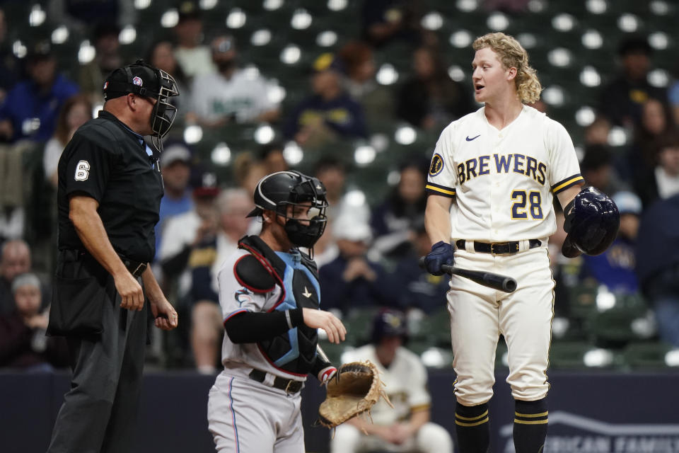 Milwaukee Brewers' Joey Wiemer (28) argues a call with umpire Mark Carlson during the second inning of a baseball game against the Miami Marlins, Monday, Sept. 11, 2023, in Milwaukee. (AP Photo/Aaron Gash)