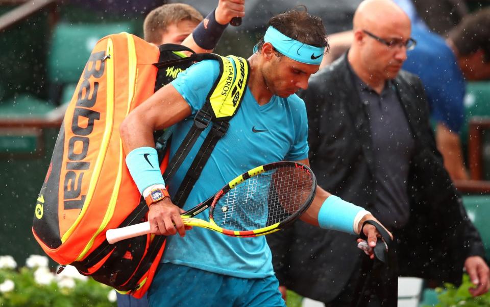 Rafael Nadal leaves the Court Philippe Chatrier following yet another rain interruption during his French OIpen quarter-final with Diego Schwartzman on Wednesday evening - Getty Images Europe
