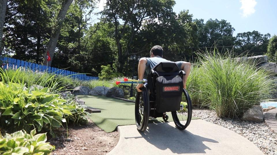 Scott Chesney wheels up an incline to the green. Reporter Gene Myers and Verona's Scott Chesney share mishaps and adventure while considering ADA guidelines, here in at Castle Cove Mini Golf in Jefferson, NJ on July 22, 2022.