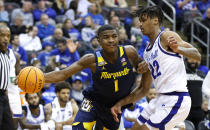 Marquette guard Kam Jones (1) drives to the basket against Seton Hall forward Tae Davis (22) during the second half of an NCAA college basketball game in Newark, N.J., Saturday, Jan. 21, 2023. (AP Photo/Noah K. Murray)