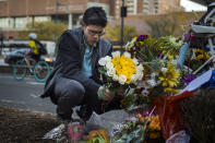 <p>Simon Rubin, 25, arranges flowers at a makeshift memorial to remember the victims of the recent truck attack near the crime scene on Thursday, Nov. 2, 2017, in New York. (Photo: Andres Kudacki/AP) </p>