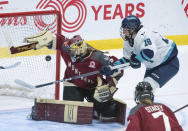 Montreal goaltender Ann-Renee Desbiens (35) makes a save next to New York's Elizabeth Giguere (18) during the third period of a PWHL hockey game Wednesday, April 24, 2024, in Montreal. (Christinne Muschi/The Canadian Press via AP)