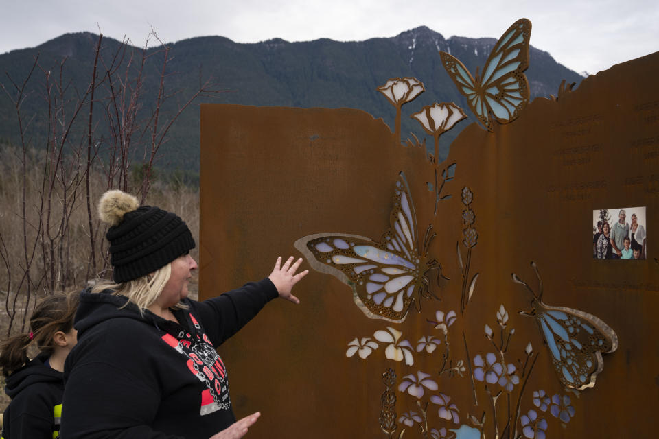 Jessica Pszonka talks about the memorial for her family members who were lost in the Oso landslide on Saturday, Feb. 17, 2024, in Oso, Wash. Jessica Pszonka lost her sister Katie, two nephews, and three other family members in the slide. After the landslide, Pszonka promised herself and her family to see a permanent memorial created where relatives and visitors could feel her sister’s presence and reflect on the serenity that drew the family to Oso, as well as the forces that left an immense scar in the forested Cascade Mountain foothills. (AP Photo/Jenny Kane)