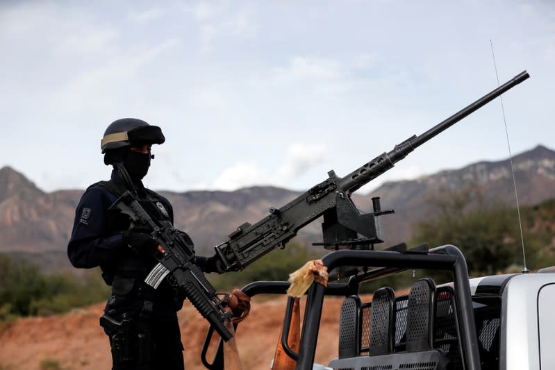 A police officer guards the entrance of the Mormon community La Mora