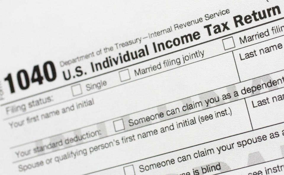 FILE - This July 24, 2018, file photo shows a portion of the 1040 U.S. Individual Income Tax Return form. The Trump administration is working on plans to delay the April 15 federal tax deadline for most individual taxpayers as well as small businesses. Treasury Secretary Steven Mnuchin told Congress on Wednesday, March 11, 2020, that the administration is "looking at providing relief to certain taxpayers and small businesses who will be able to get extensions on their taxes." (AP Photo/Mark Lennihan, File)