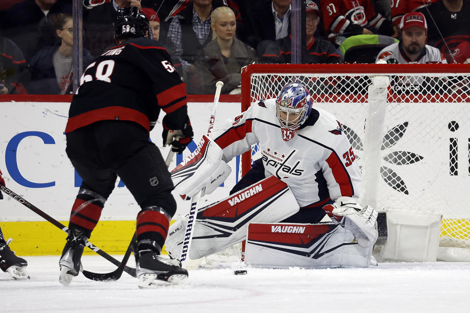 Carolina Hurricanes' Michael Bunting (58) has his shot blocked by Washington Capitals goaltender Darcy Kuemper (35) during the first period of an NHL hockey game in Raleigh, N.C., Sunday, Dec. 17, 2023. (AP Photo/Karl B DeBlaker)