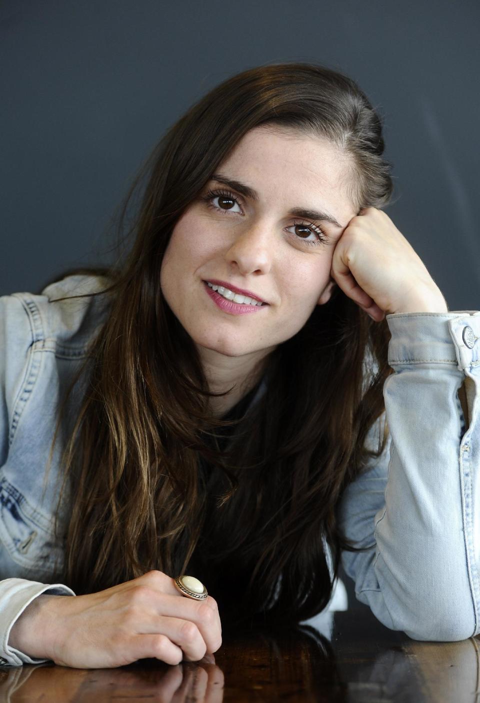 In this photo taken Friday, May 2, 2014 Rosa da Silva, in the role of Anne, poses during an interview with the Associated Press at Theater Amsterdam. Seeking to engage a new generation with the tragic story of Anne Frank, a major new play based on the Jewish teenager's diary opens Thursday, May 8, 2014 in Amsterdam. It's the first time a theatrical production has been forged directly from Frank's actual writings since the award-winning 1950s play that escalated her story, then little-known, to the world's attention. It's being staged in a purpose-built 1,100 seat theater that includes a replica of the secret apartment where Frank and her family hid from the Nazis in World War II. (AP Photo/Evert Elzinga)