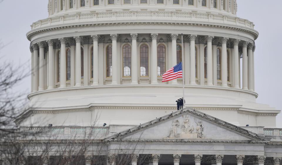 Capitol Hill Police salute as they lower the United States flag over the United States Capitol to half-staff on Jan. 8, 2021 after House Speaker Nancy Pelosi ordered the flags at the U.S. Capitol to be flown at half-staff following the death of U.S. Capitol Police Officer Officer Brian Sicknick who died after he was injured when President Donald Trump's supporters stormed the Capitol.