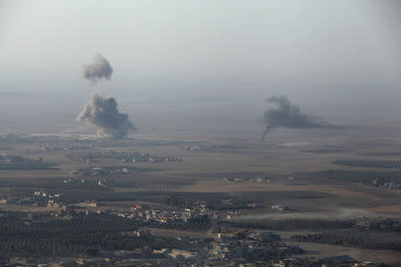 Smoke rises at Islamic State militants' positions in the town of Naweran near Mosul. REUTERS/Azad Lashkari