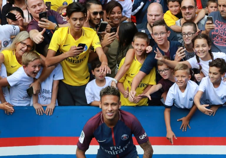 Paris Saint-Germain's new signing Neymar poses for a photo during his presentation to the fans at the Parc des Princes stadium in Paris, on August 5, 2017