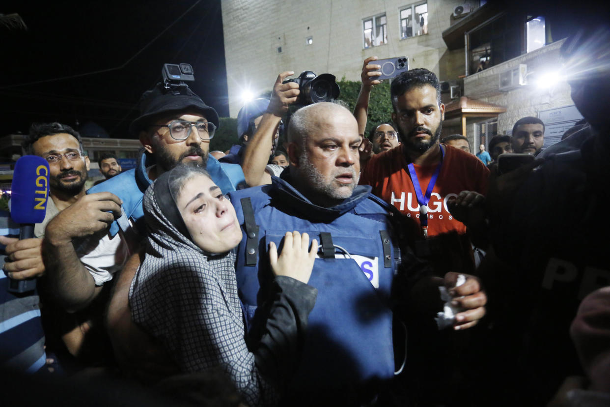 Al Jazeera reporter Wael Dahdouh carries his injured son from an ambulance to a hospital in Gaza City, Gaza on Oct. 25.